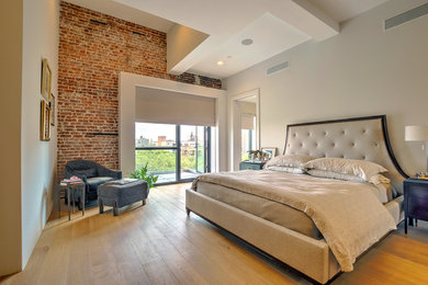 Large trendy master light wood floor bedroom photo in Tampa with white walls and no fireplace