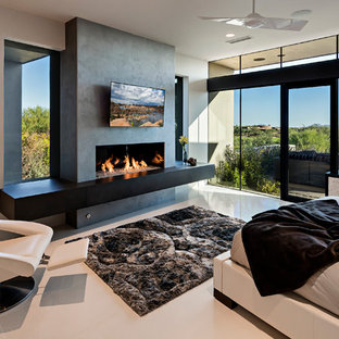 Large modern master bedroom in Phoenix with beige walls, porcelain floors, a ribbon fireplace and a concrete fireplace surround.