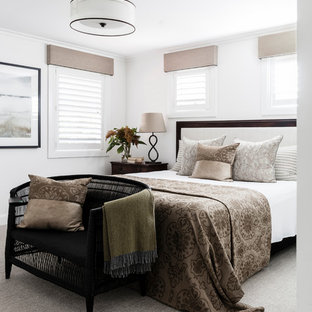 This is an example of a transitional bedroom in Sydney with white walls, carpet and grey floor.