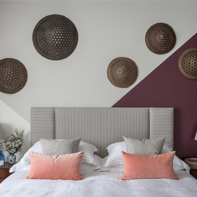 Example of a trendy bedroom design in London with purple walls