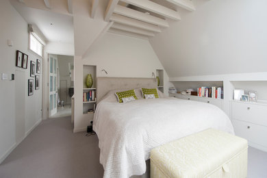 Design ideas for a medium sized farmhouse bedroom in London with white walls, carpet and grey floors.