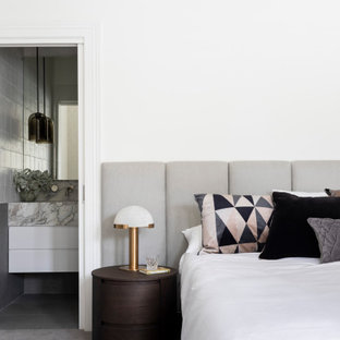 Photo of a mid-sized contemporary master bedroom in Melbourne with white walls, carpet and grey floor.