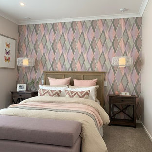 Transitional guest bedroom in Brisbane with multi-coloured walls, carpet, no fireplace and brown floor.