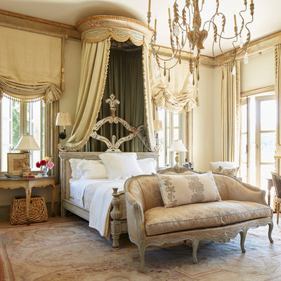 Example of a tuscan master bedroom design in Los Angeles with beige walls and no fireplace