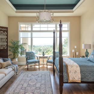 Example of a classic dark wood floor bedroom design in Austin with beige walls