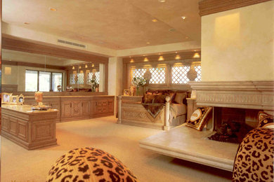 Example of a large ornate master carpeted and beige floor bedroom design in Las Vegas with beige walls, a standard fireplace and a stone fireplace