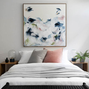 This is an example of a mid-sized contemporary guest bedroom in Melbourne with white walls, carpet and beige floor.