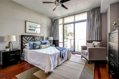 Mid-sized transitional master medium tone wood floor and brown floor bedroom photo in Atlanta with gray walls
