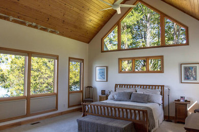 Example of a mid-sized arts and crafts master carpeted and shiplap ceiling bedroom design in Other with white walls and no fireplace