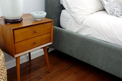 Foto de dormitorio principal retro de tamaño medio con paredes blancas, suelo de madera en tonos medios y suelo marrón