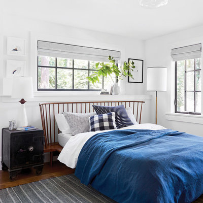 Example of a country bedroom design in Portland with white walls and no fireplace