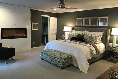 Imagen de dormitorio principal contemporáneo grande con paredes verdes, moqueta, chimenea lineal y marco de chimenea de baldosas y/o azulejos