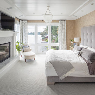 Bedroom - transitional carpeted and gray floor bedroom idea in Portland with beige walls, a standard fireplace and a stone fireplace