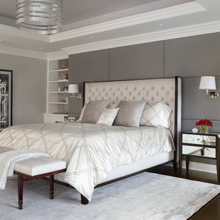 Large transitional master dark wood floor and brown floor bedroom photo in New York with gray walls