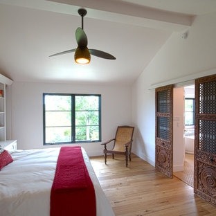 Inspiration for a mid-sized contemporary master bedroom in Austin with white walls, light hardwood floors and no fireplace.