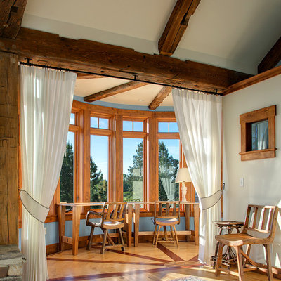 Elegant medium tone wood floor bedroom photo in Seattle with white walls