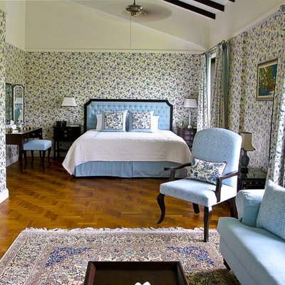 Elegant medium tone wood floor bedroom photo in Singapore with yellow walls