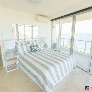 Imagen de habitación de invitados marinera, de tamaño medio, con paredes blancas y suelo de travertino