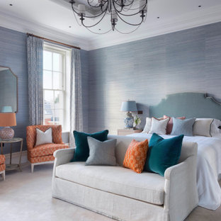 Design ideas for a classic master bedroom in Surrey with blue walls, carpet, grey floors and wallpapered walls.