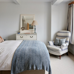 Small coastal guest bedroom in Hampshire with white walls, carpet and beige floors.