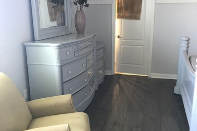 Small minimalist master laminate floor and gray floor bedroom photo in Orlando with gray walls