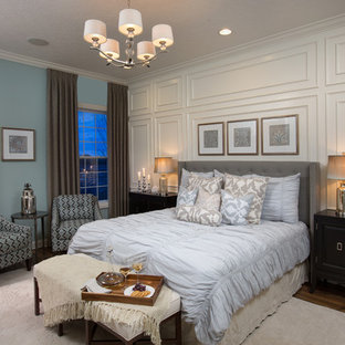 Example of a transitional guest dark wood floor bedroom design in Columbus with blue walls