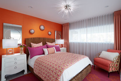 Example of a small trendy guest porcelain tile and gray floor bedroom design in Miami with orange walls and no fireplace