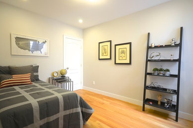 Bedroom - small contemporary guest medium tone wood floor bedroom idea in San Francisco with gray walls