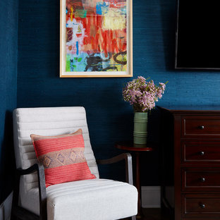 This is an example of an eclectic bedroom in Chicago with blue walls, dark hardwood floors and brown floor.