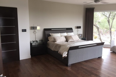 Example of a mid-sized trendy master dark wood floor bedroom design in Phoenix with beige walls and no fireplace