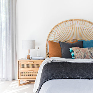 Photo of a beach style bedroom in Wollongong with white walls and white floor.