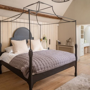 Photo of a coastal master bedroom in Cornwall with beige walls, light hardwood flooring, no fireplace and beige floors.