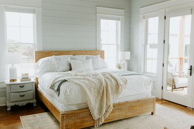 Inspiration for a cottage guest medium tone wood floor bedroom remodel in Atlanta with gray walls