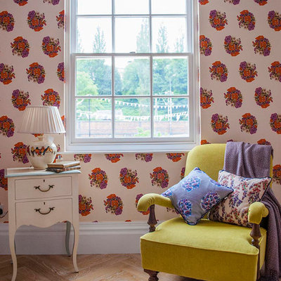 Example of a classic light wood floor bedroom design in London with multicolored walls