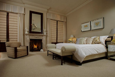 Bedroom - large traditional master carpeted and beige floor bedroom idea in New York with beige walls, a standard fireplace and a wood fireplace surround