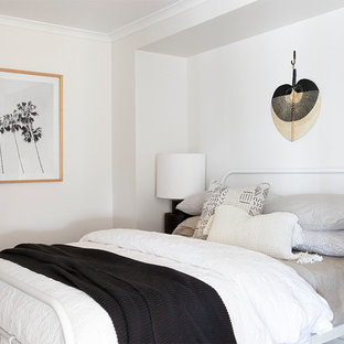 This is an example of a beach style bedroom in Gold Coast - Tweed with white walls and no fireplace.