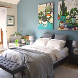 This is an example of a contemporary master bedroom in Other with blue walls and brown floor.