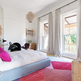 Inspiration for a transitional bedroom in Melbourne with white walls and a standard fireplace.