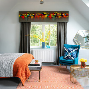 Bohemian bedroom in Buckinghamshire with white walls, carpet, grey floors and a vaulted ceiling.