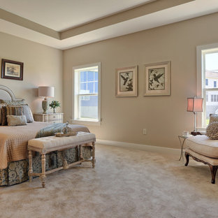 Example of a large transitional master carpeted and beige floor bedroom design in Other with beige walls
