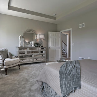 Example of a large transitional master carpeted and beige floor bedroom design in Other with beige walls
