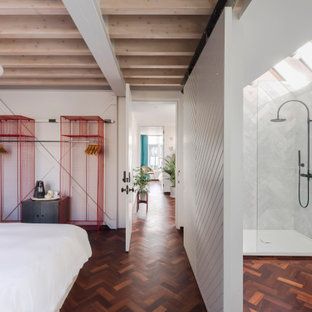 Inspiration for a contemporary master bedroom in London with white walls, dark hardwood flooring, brown floors and exposed beams.