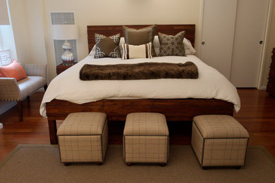 Modelo de dormitorio principal contemporáneo de tamaño medio con paredes beige y suelo de madera oscura