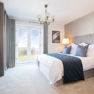 Design ideas for a contemporary bedroom in Other with white walls, carpet, no fireplace and beige floors.