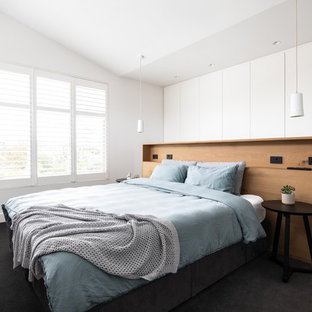 Photo of a contemporary bedroom in Melbourne with white walls, carpet and grey floor.