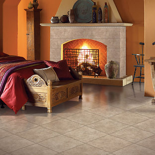 Foto de dormitorio principal, mediterráneo, de tamaño medio, con parades naranjas, suelo de baldosas de porcelana, chimenea tradicional, marco de chimenea de baldosas y/o azulejos y suelo beige