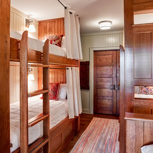 Inspiration for a mid-sized rustic guest medium tone wood floor and brown floor bedroom remodel in Burlington with gray walls and no fireplace