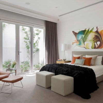 Example of a trendy carpeted bedroom design in Melbourne with white walls and no fireplace