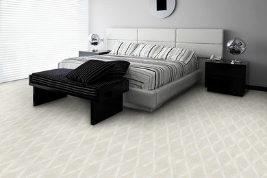 Example of a large minimalist master carpeted and beige floor bedroom design in Other with gray walls