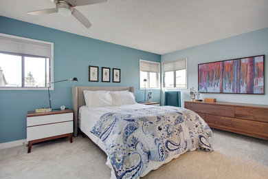 Example of a large transitional master carpeted and brown floor bedroom design in Calgary with blue walls and no fireplace